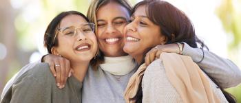 Women friends, hug and smile in park for happiness